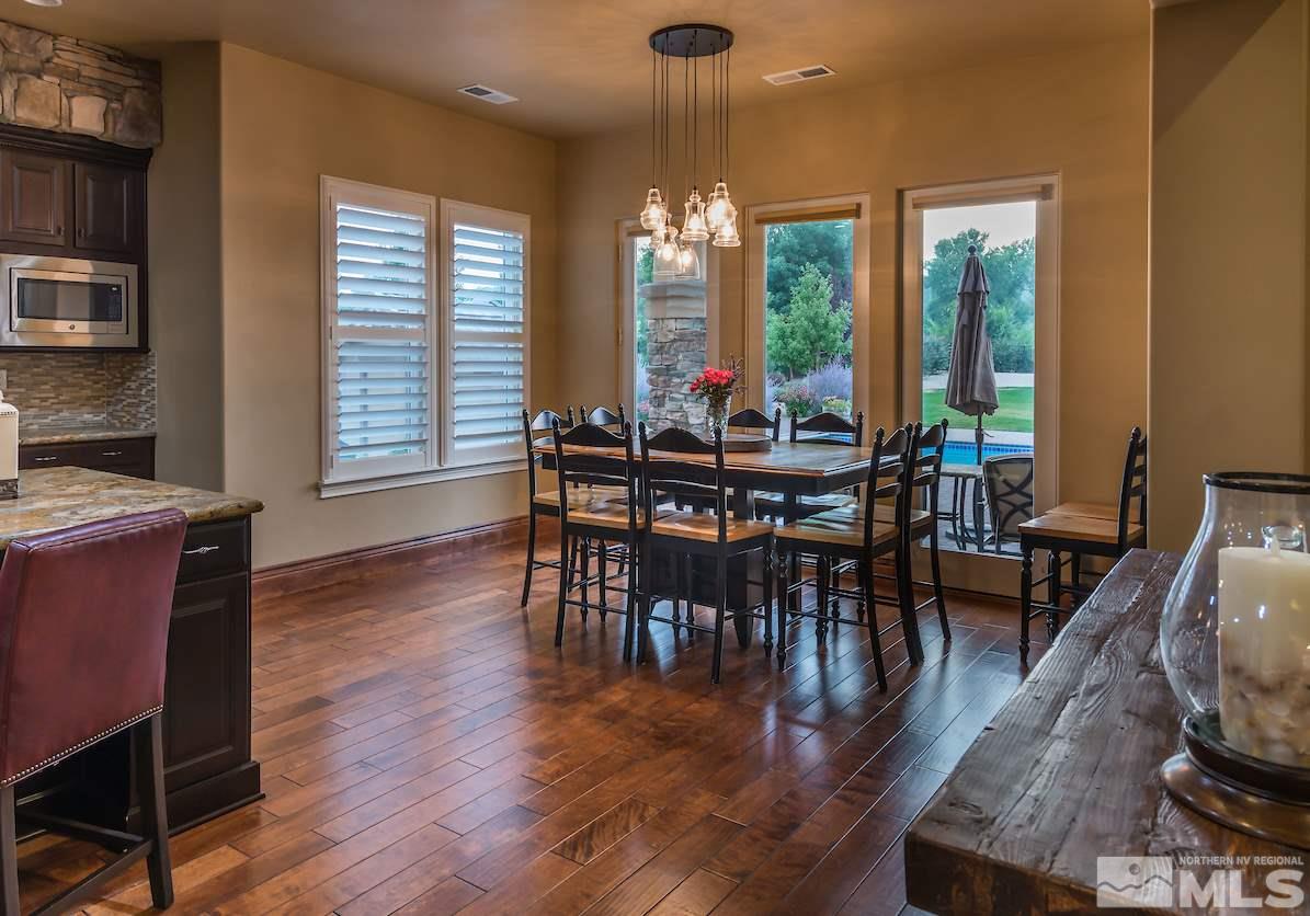 12745 Silver Wolf Road Reno, NV 89511 - Photo 5 of 21 a view of a dining room with furniture window and wooden floor