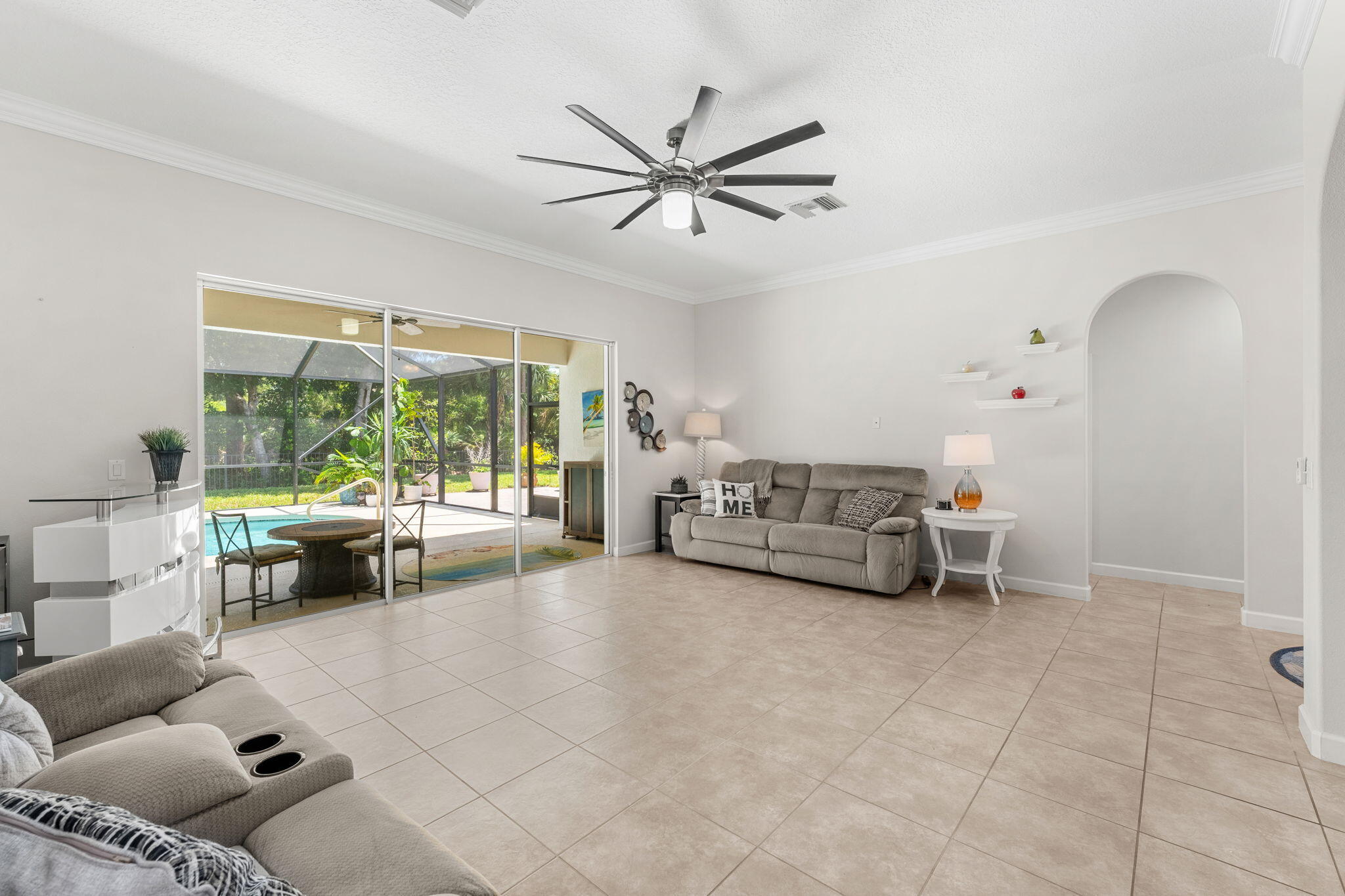 7657 Fieldstone Ranch Square Vero Beach, FL 32967 - Photo 13 of 52 a living room with furniture and a large window with garden view