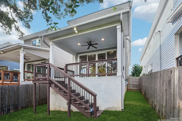 a view of house with yard and deck