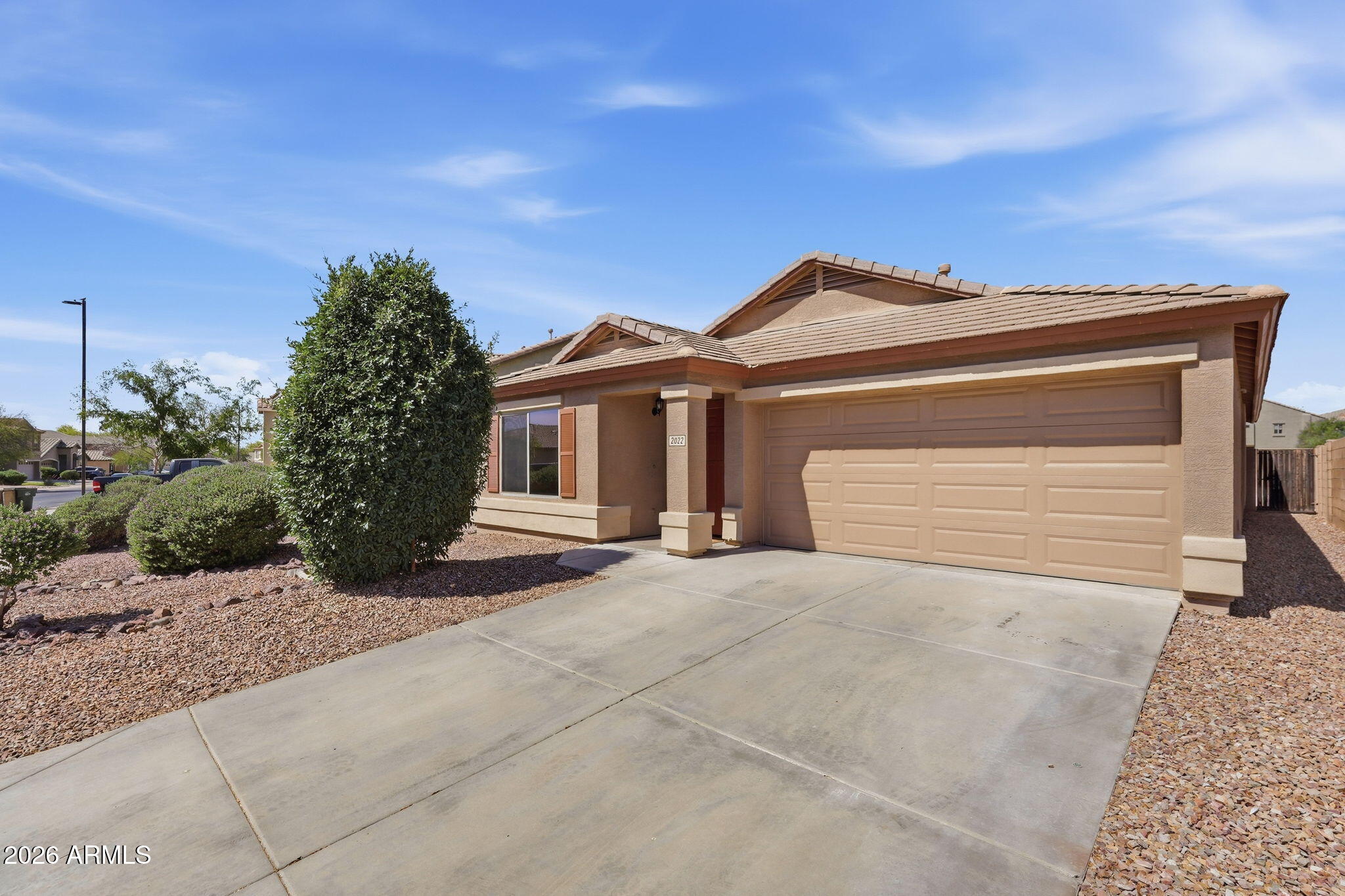 2022 South 160th Lane Goodyear, AZ 85338 - Photo 1 of 36 a front view of a house with a yard and garage