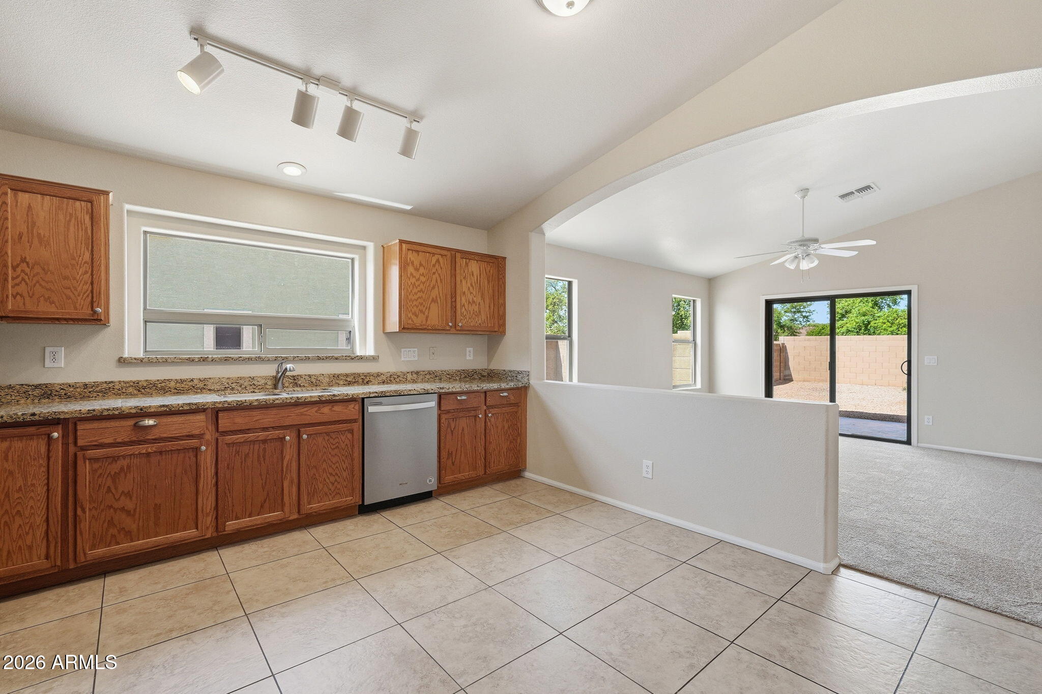 2022 South 160th Lane Goodyear, AZ 85338 - Photo 13 of 36 a large kitchen with granite countertop a sink and cabinets