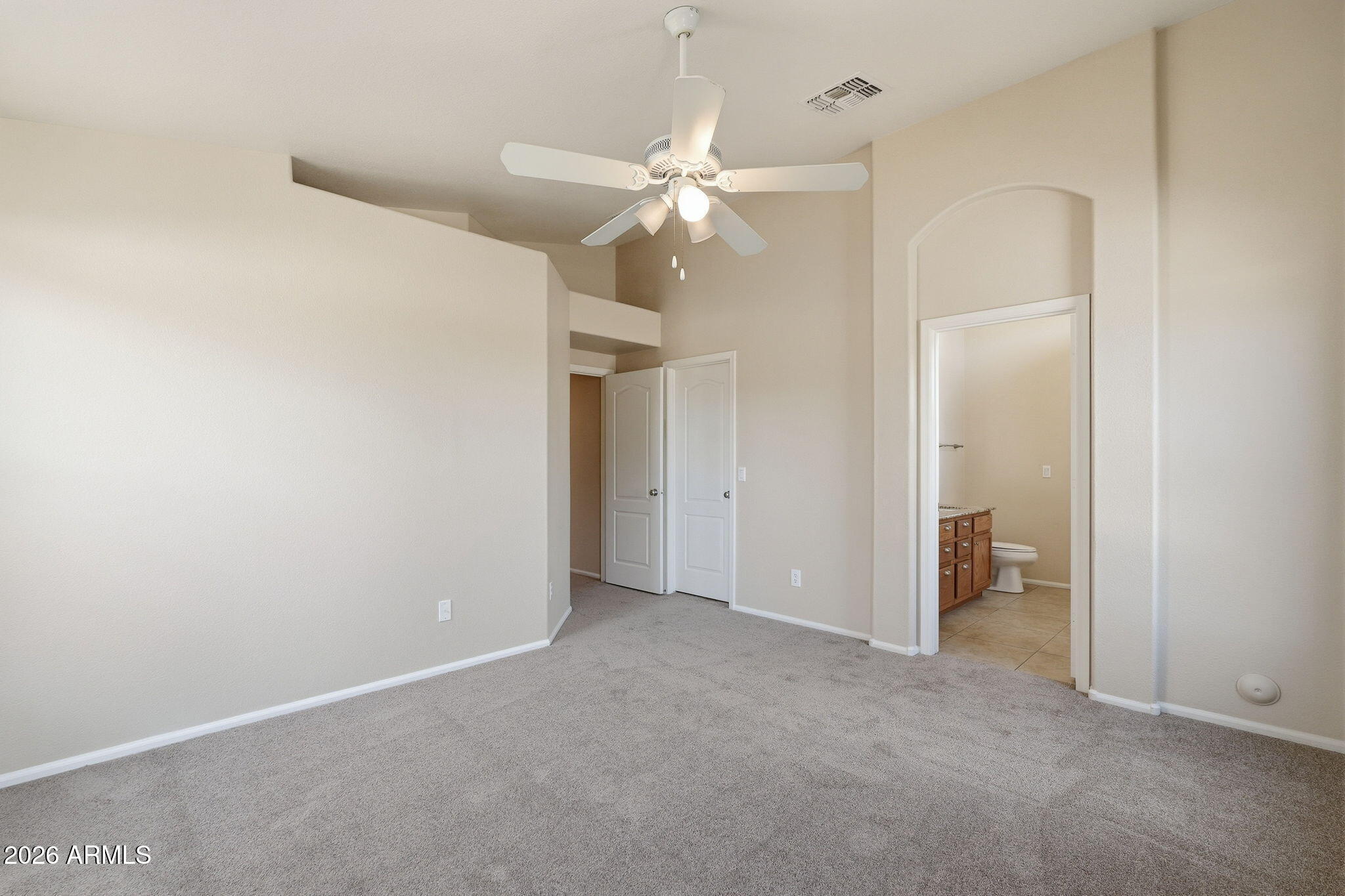 2022 South 160th Lane Goodyear, AZ 85338 - Photo 18 of 36 an empty room with closet and a ceiling fan