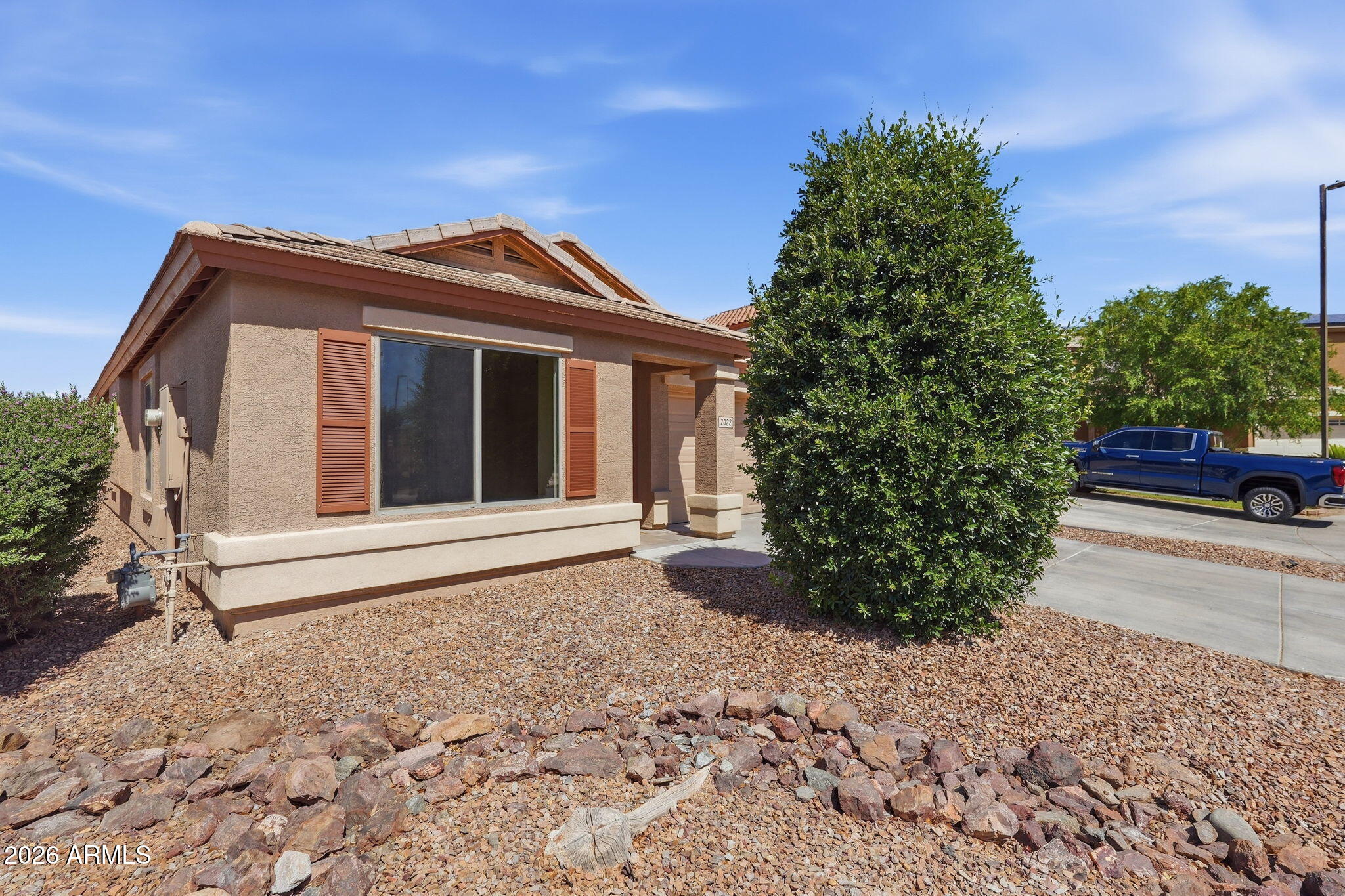 2022 South 160th Lane Goodyear, AZ 85338 - Photo 2 of 36 a front view of a house with a yard and garage