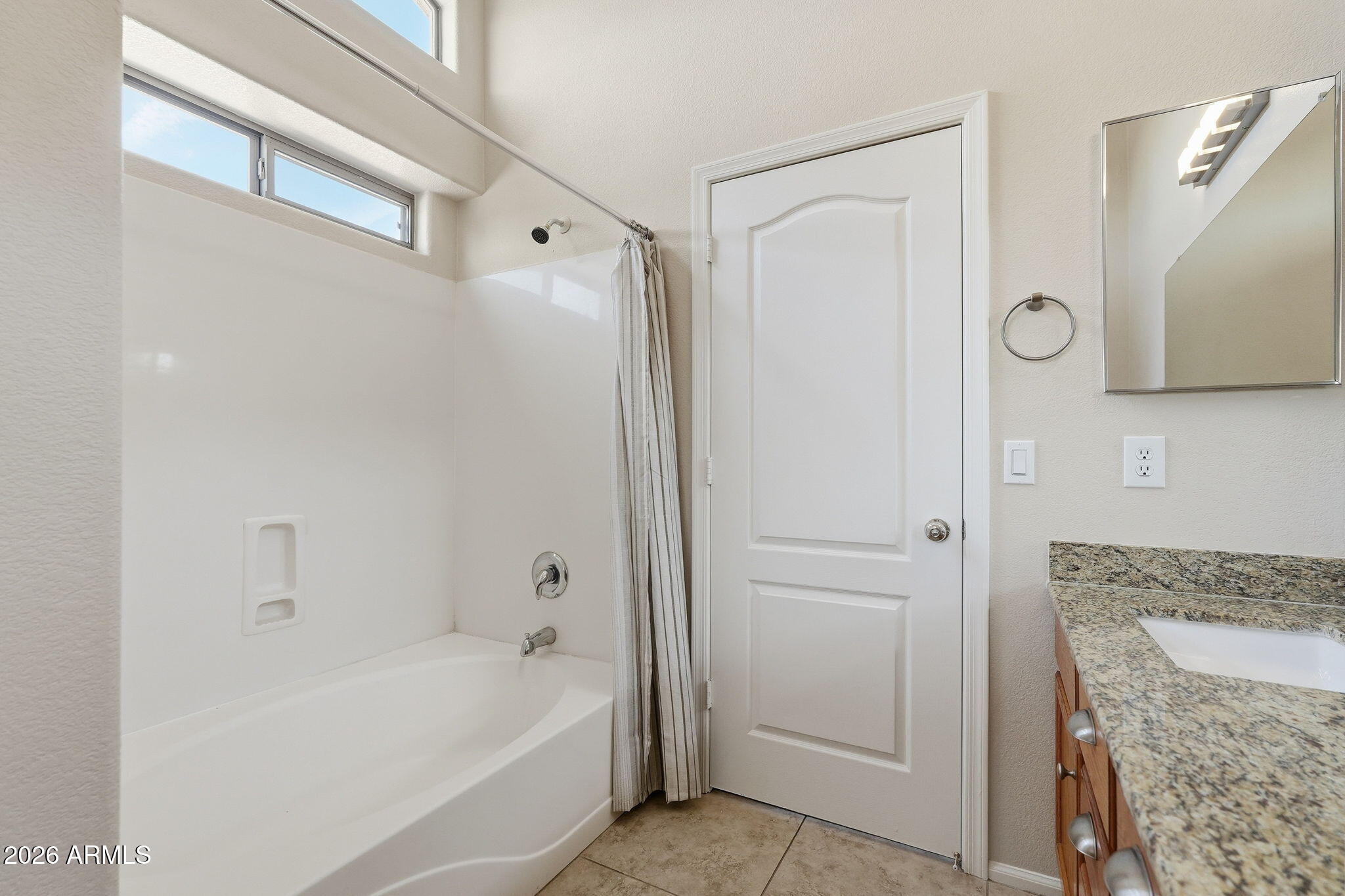 2022 South 160th Lane Goodyear, AZ 85338 - Photo 26 of 36 a bathroom with a bathtub and a shower