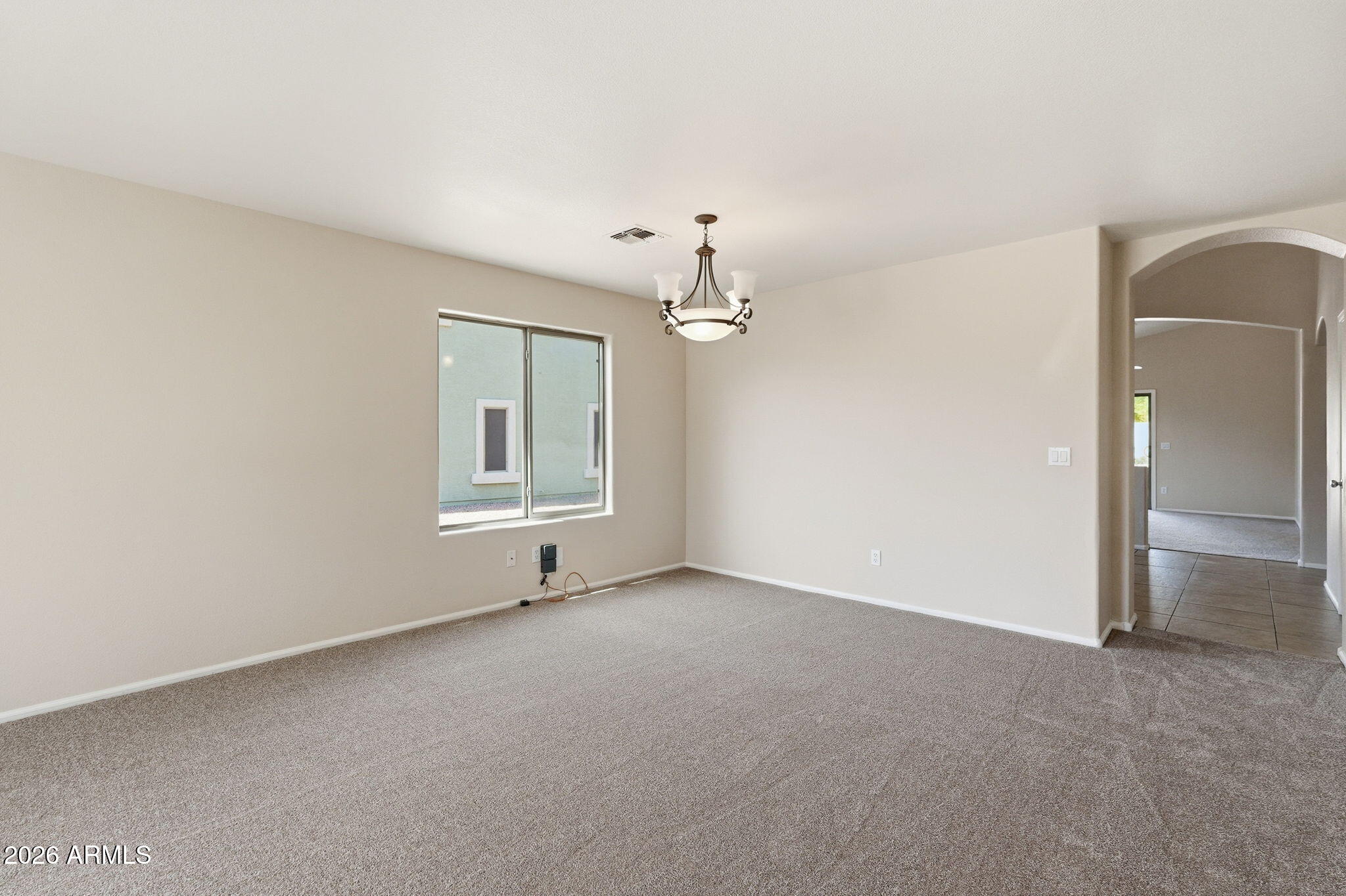 2022 South 160th Lane Goodyear, AZ 85338 - Photo 3 of 36 a view of a big room with chandelier fan and windows