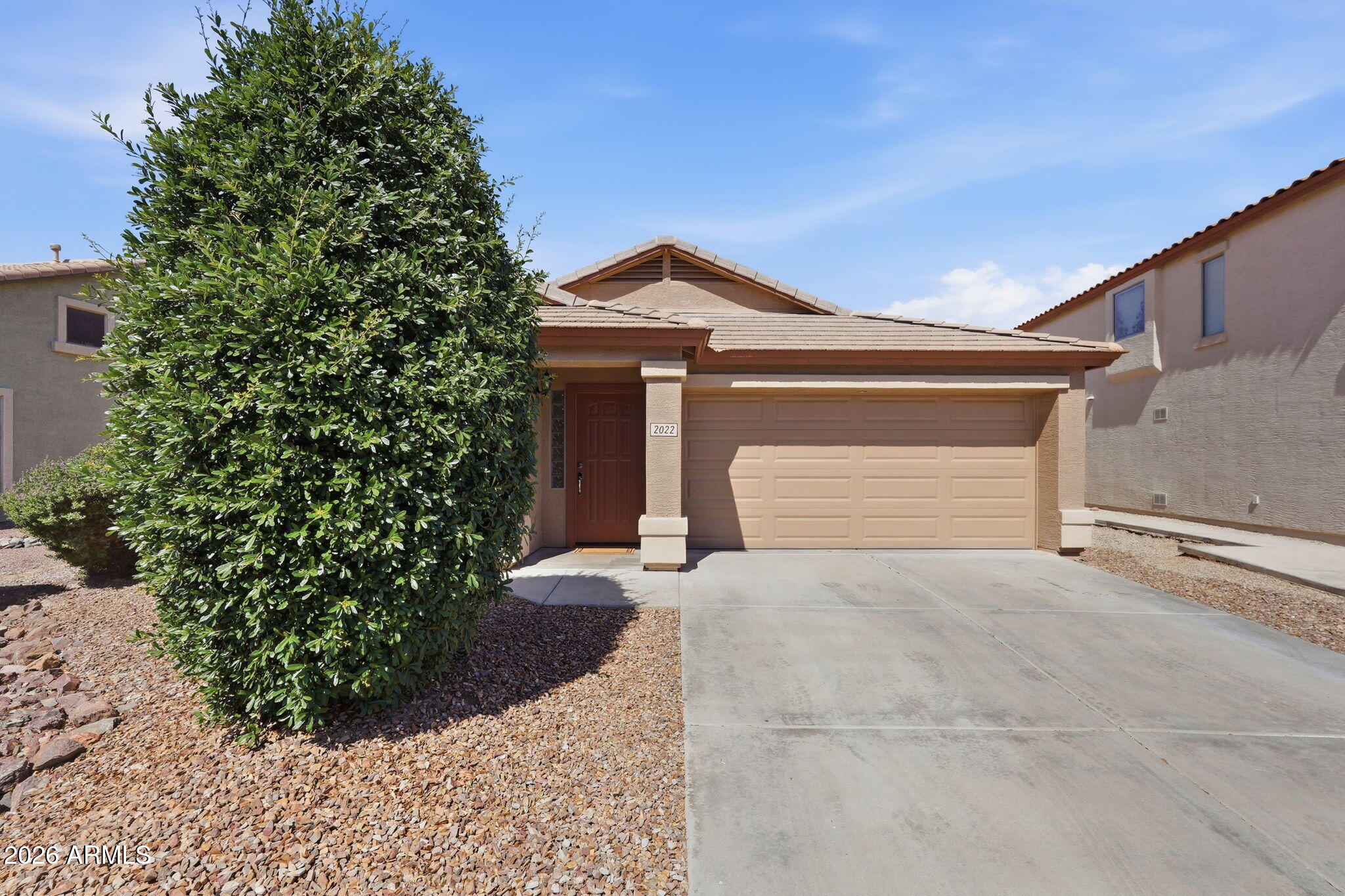 2022 South 160th Lane Goodyear, AZ 85338 - Photo 36 of 36 a front view of a house with a yard and garage