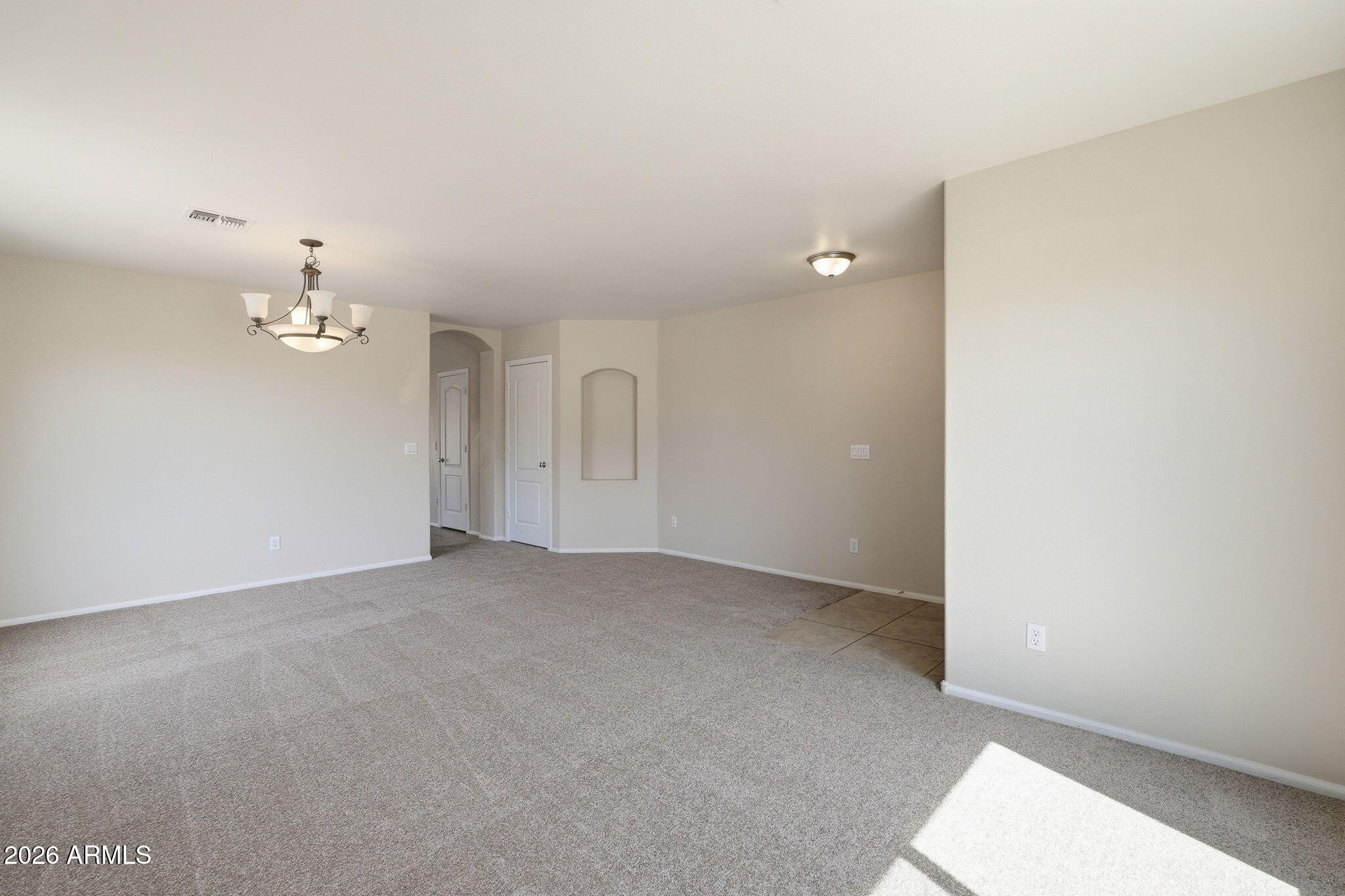 2022 South 160th Lane Goodyear, AZ 85338 - Photo 4 of 36 a view of an empty room with a chandelier fan