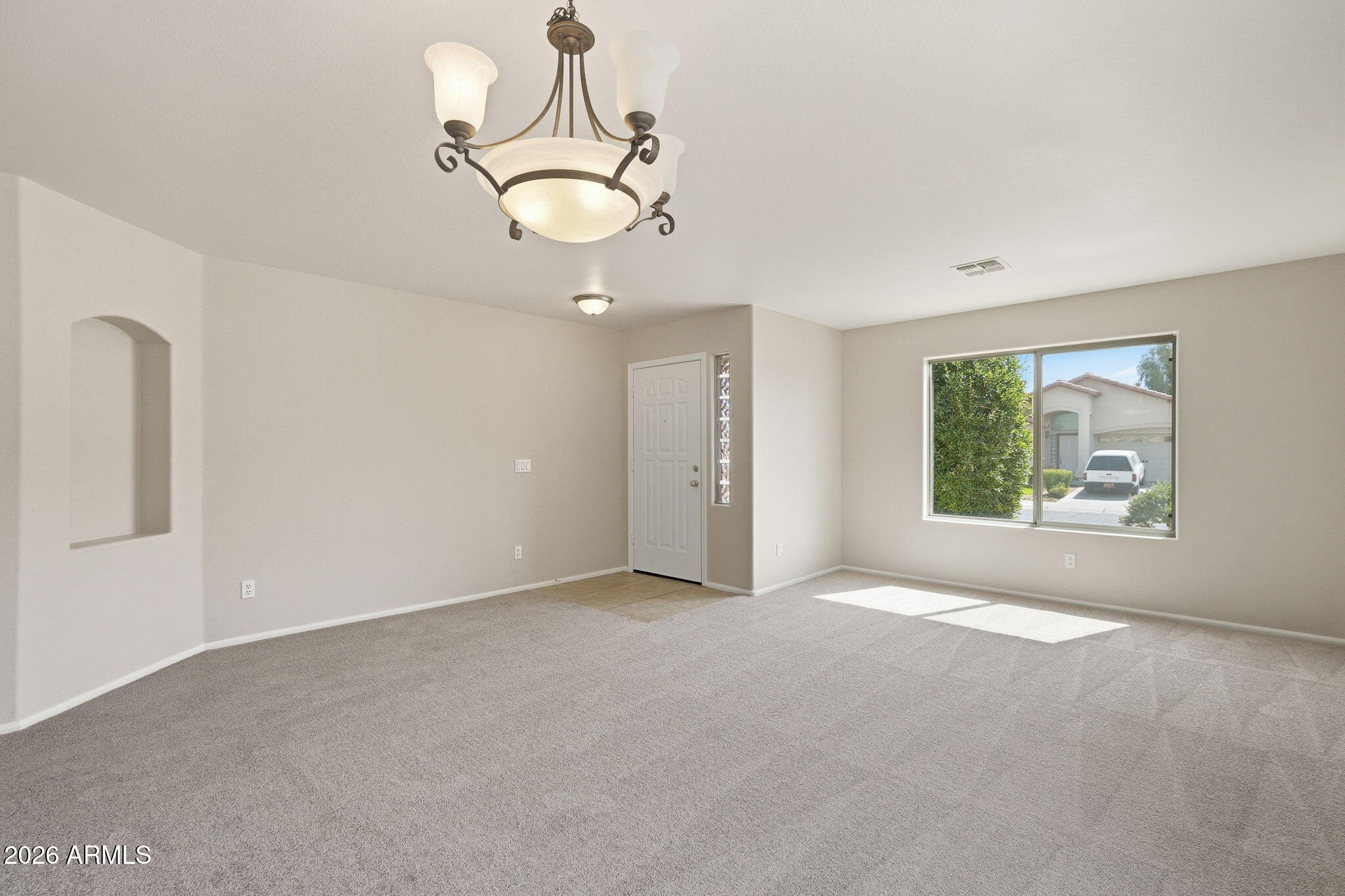 2022 South 160th Lane Goodyear, AZ 85338 - Photo 5 of 36 a view of a big room with windows and chandelier