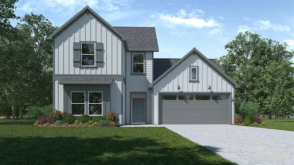 a front view of a house with a garden and yard