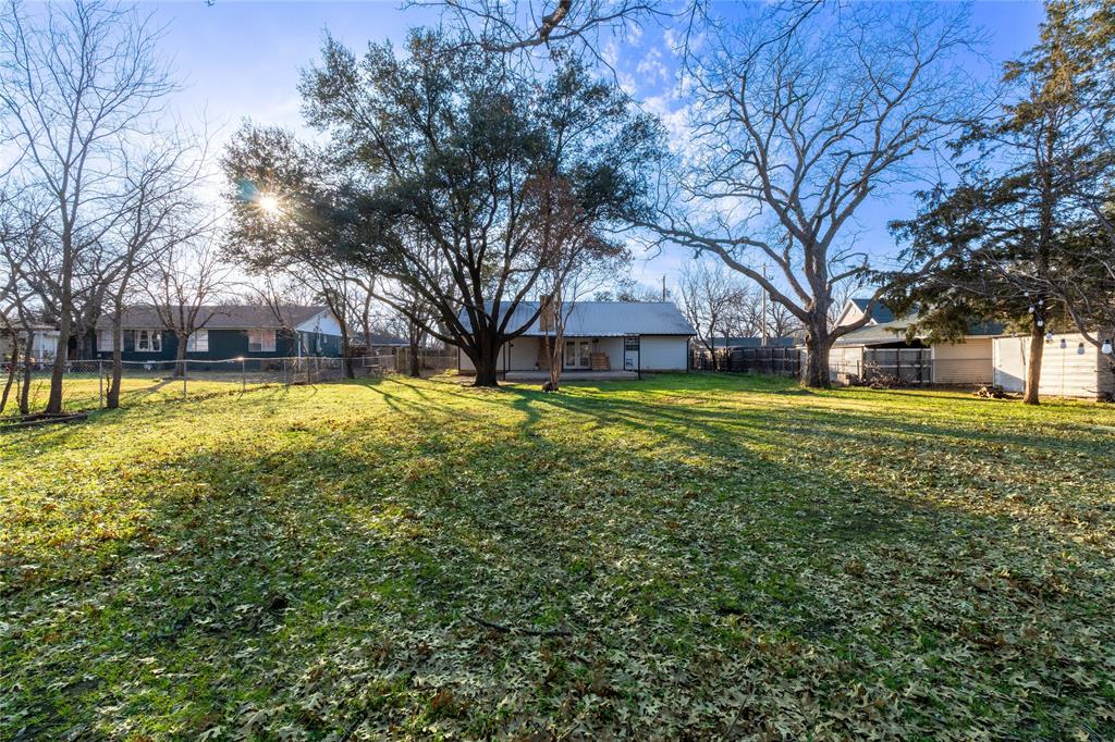 313 South Prairie Street Pilot Point, TX 76258 - Photo 14 of 16 a view of a house with a large trees