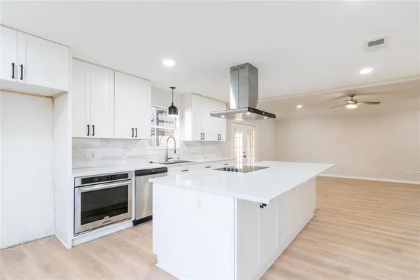 a kitchen with a stove and a sink