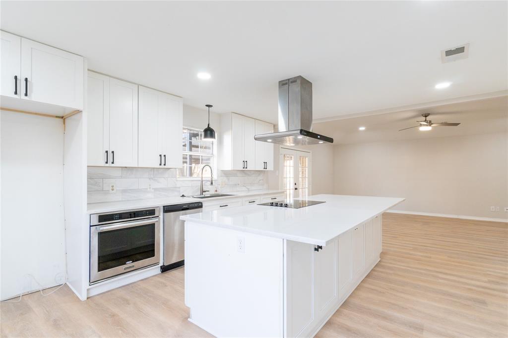 313 South Prairie Street Pilot Point, TX 76258 - Photo 4 of 16 a kitchen with a stove and a sink