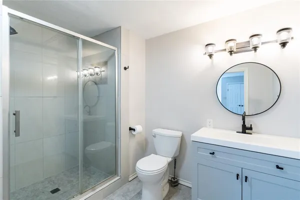 a bathroom with a toilet sink and shower