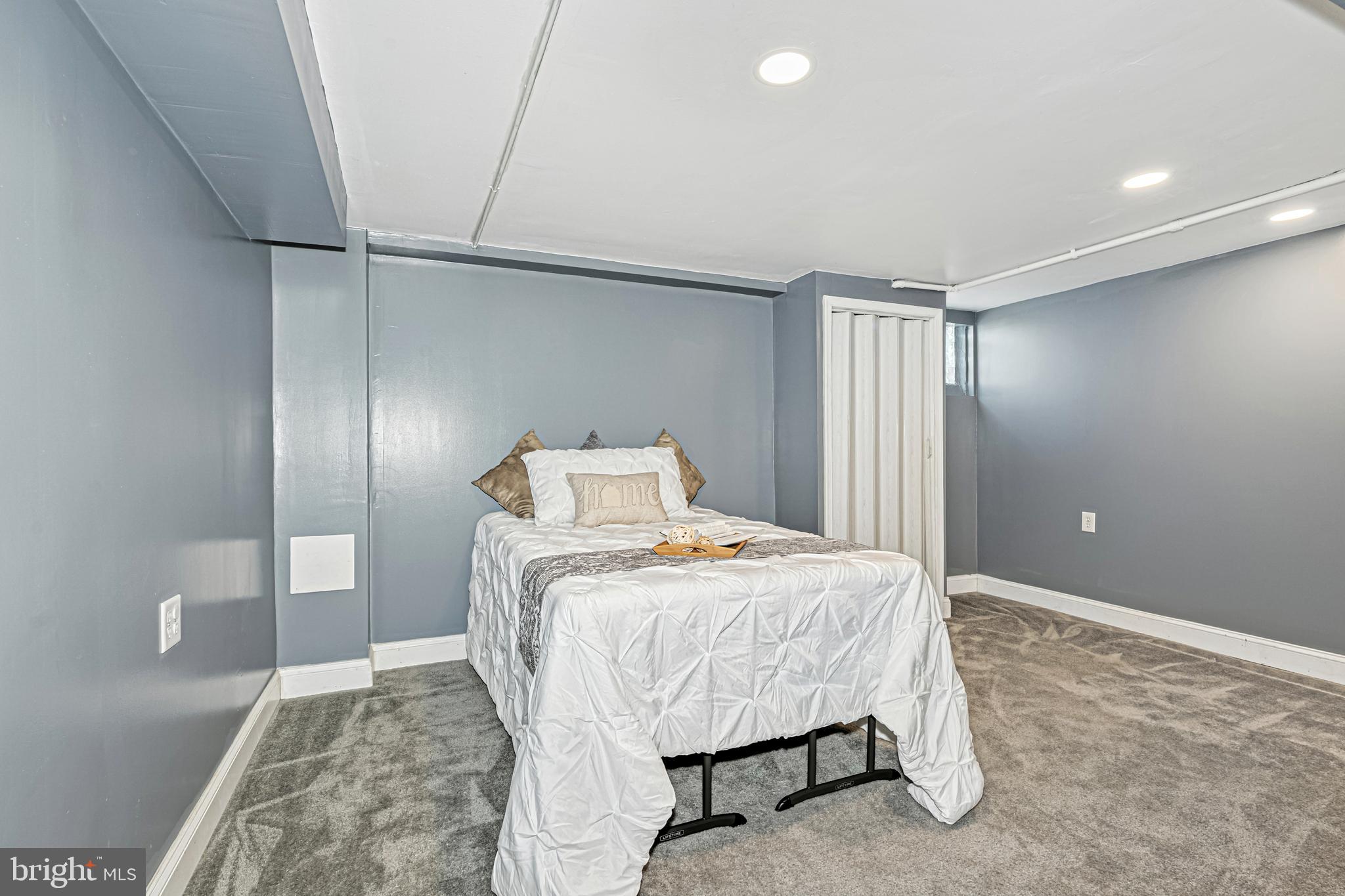 8272 Kavanagh Road Baltimore, MD 21222 - Photo 12 of 32 a bedroom with a bed and a walk in closet