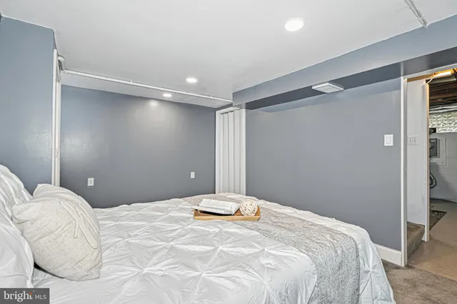 a bedroom with a large bed and a chandelier