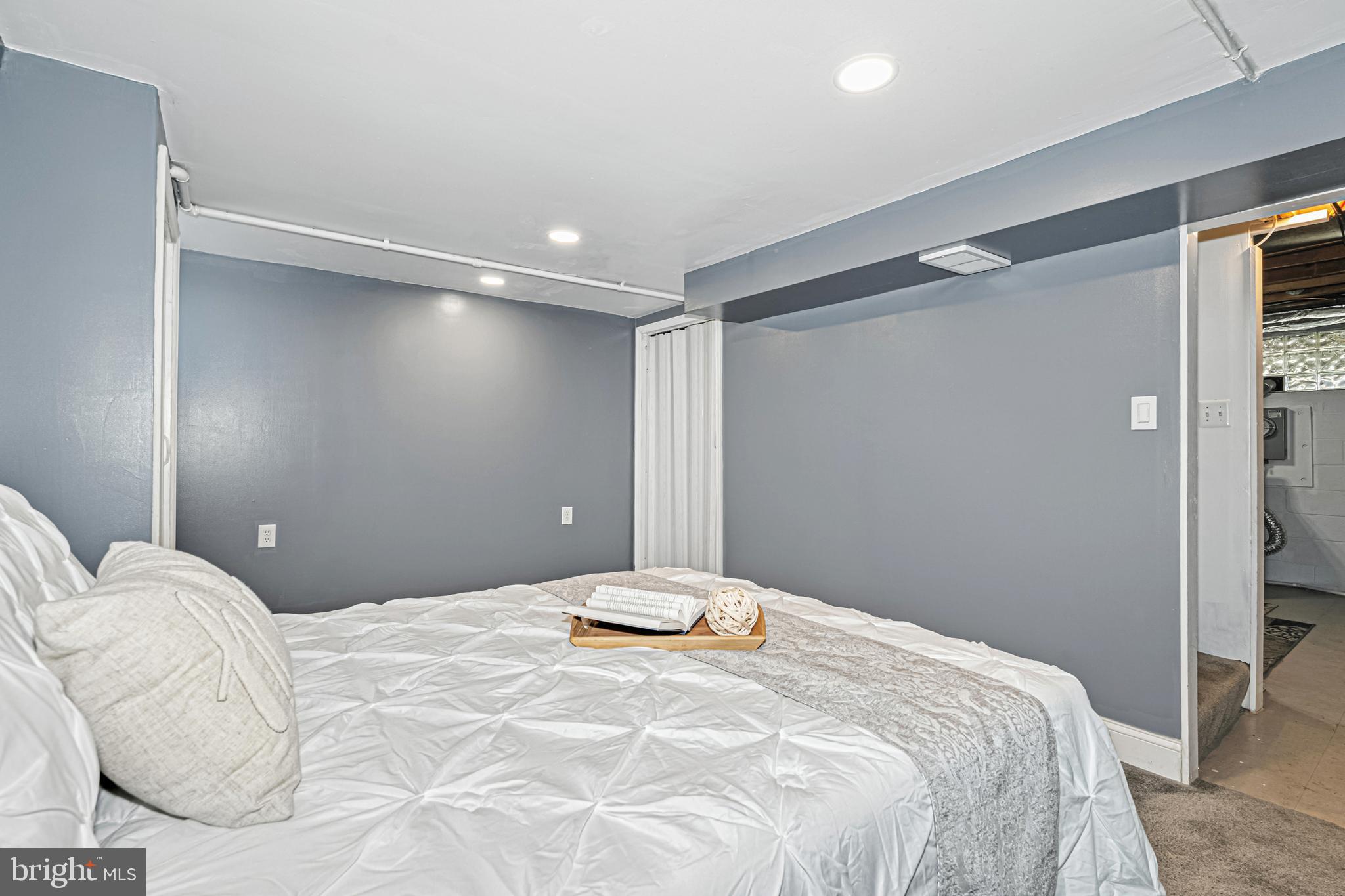 8272 Kavanagh Road Baltimore, MD 21222 - Photo 14 of 32 a bedroom with a large bed and a chandelier