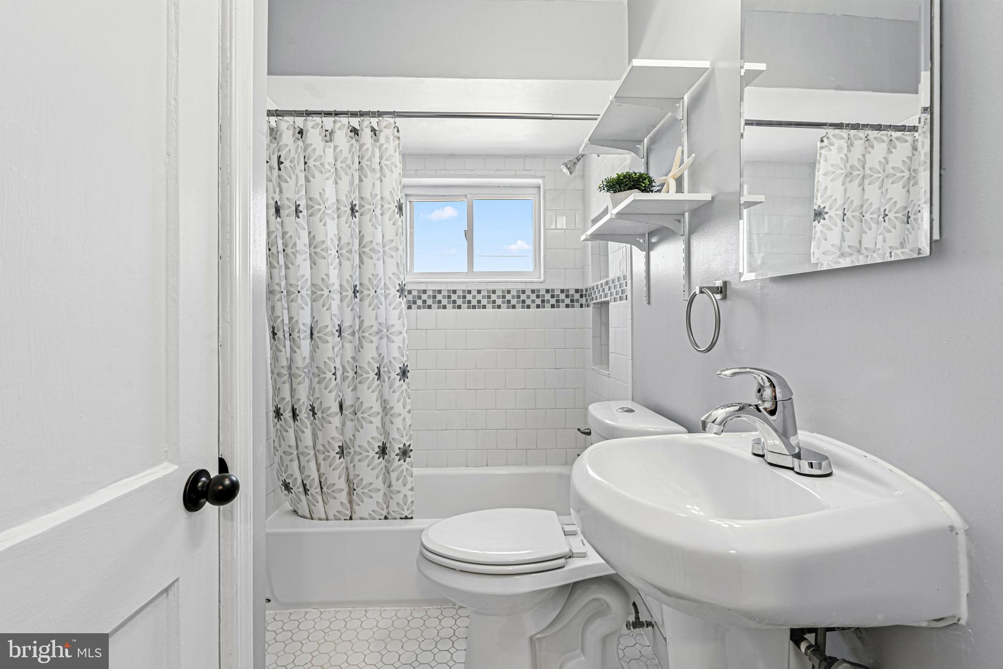 8272 Kavanagh Road Baltimore, MD 21222 - Photo 23 of 32 a bathroom with a sink toilet and shower