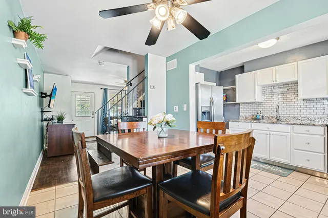 a dining room with furniture a rug and wooden floor
