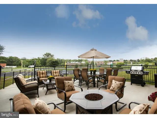 a view of a patio with couches table and chairs