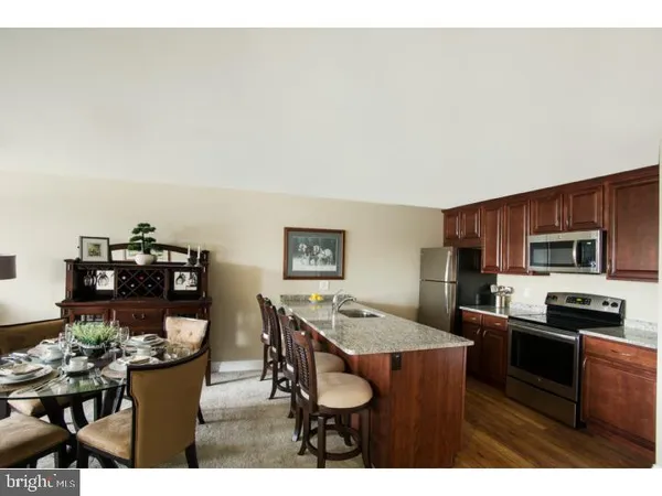 a kitchen with a table and chairs in it