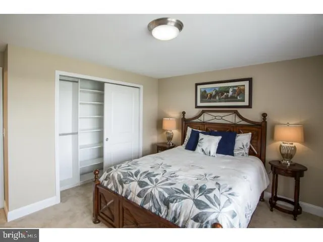 a bedroom with a bed and a lamp