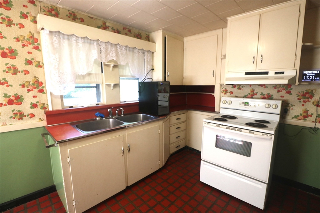 27 Henry Street Sharon, MA 02067 - Photo 3 of 19 a kitchen with a sink stove and cabinets