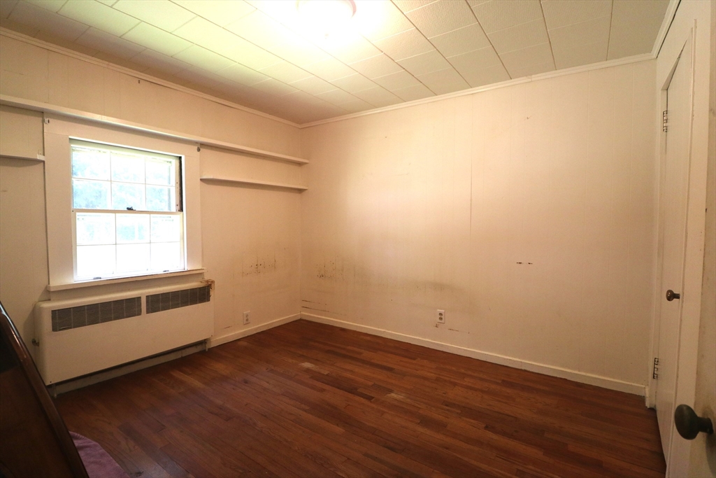 27 Henry Street Sharon, MA 02067 - Photo 7 of 19 a view of a room with wooden floor and brick walls
