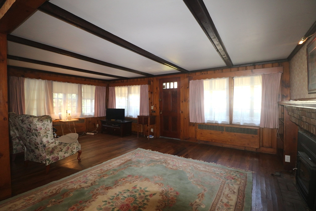 27 Henry Street Sharon, MA 02067 - Photo 10 of 19 a living room with furniture and a fireplace