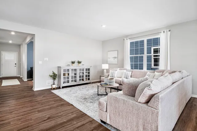 a living room with furniture window and wooden floor