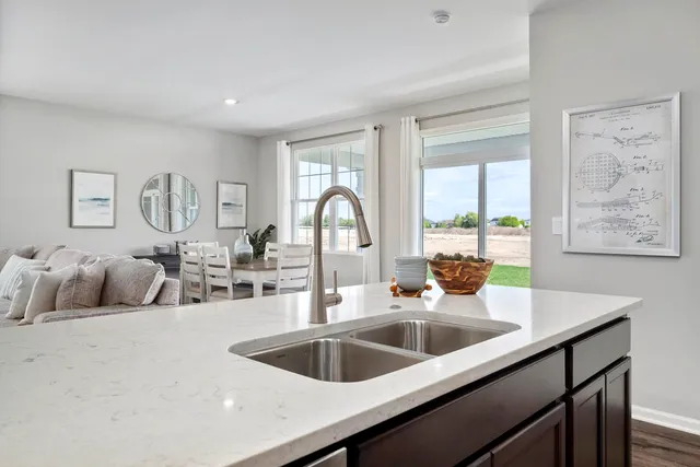 a kitchen with a sink and a refrigerator