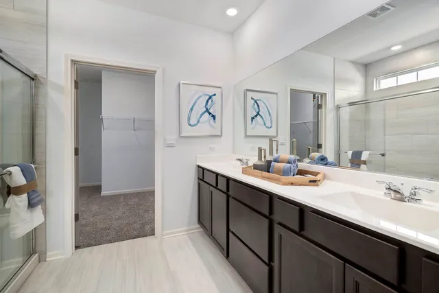 a bathroom with a sink a mirror and a shower