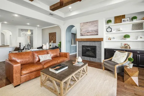a kitchen with granite countertop a table chairs stove a sink and dishwasher