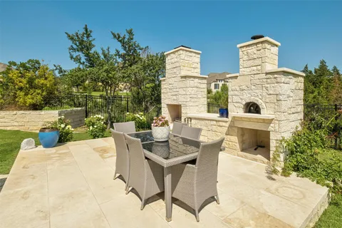 a spacious bathroom with a granite countertop sink a rug and a shower