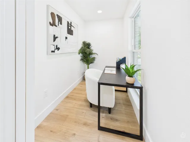 a view of a hallway with a potted plant on a table