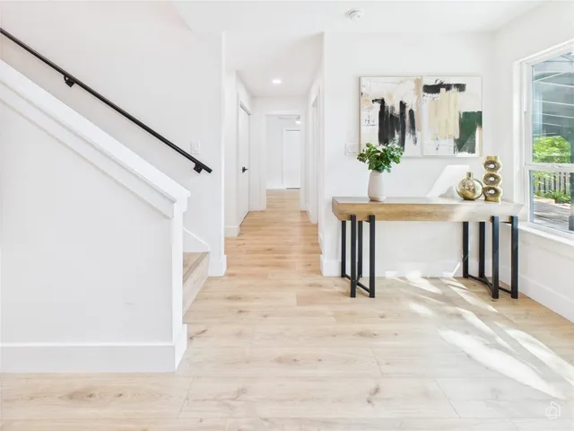 a view of living room kitchen with furniture and wooden floor
