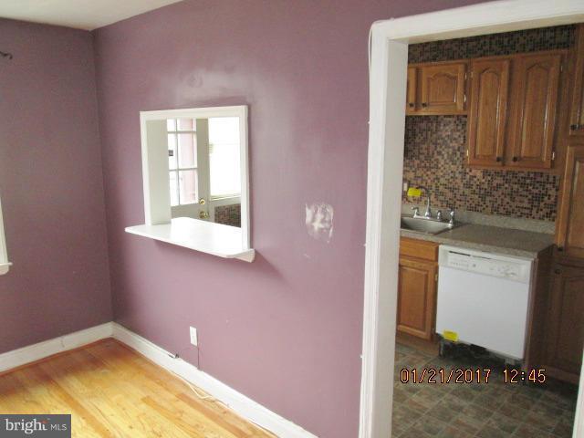 4416 Eldone Road Baltimore, MD 21229 - Photo 5 of 21 a bathroom with a granite countertop sink and a mirror