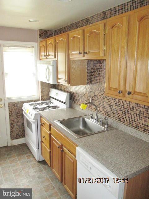 4416 Eldone Road Baltimore, MD 21229 - Photo 7 of 21 a kitchen with a sink and a stove