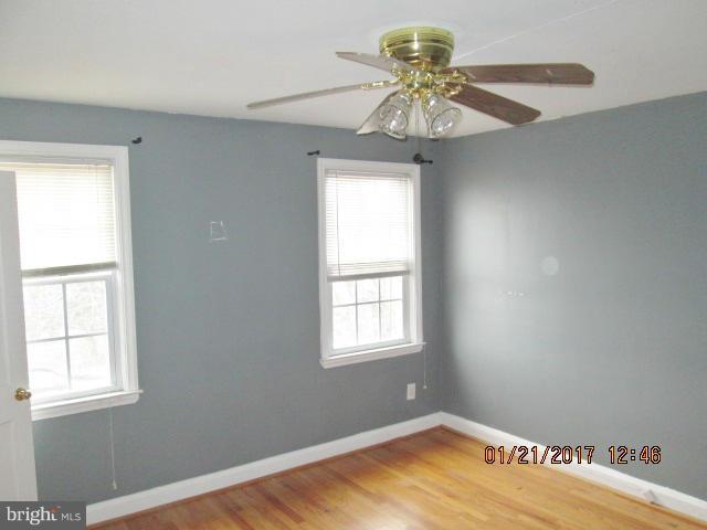 4416 Eldone Road Baltimore, MD 21229 - Photo 10 of 21 a view of empty room with window and chandelier fan