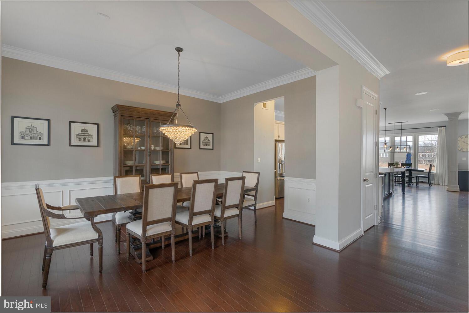 41729 Bloomfield Path Street Ashburn, VA 20148 - Photo 14 of 65 a dining room with furniture wooden floor a rug and a chandelier
