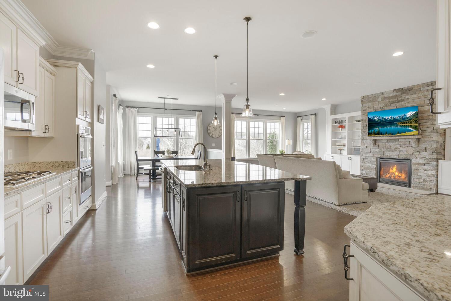 41729 Bloomfield Path Street Ashburn, VA 20148 - Photo 20 of 65 a kitchen with stainless steel appliances granite countertop a stove and a wooden floors