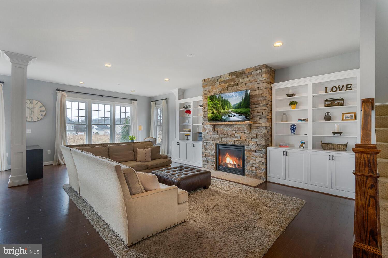 41729 Bloomfield Path Street Ashburn, VA 20148 - Photo 25 of 65 a living room with furniture and a fireplace