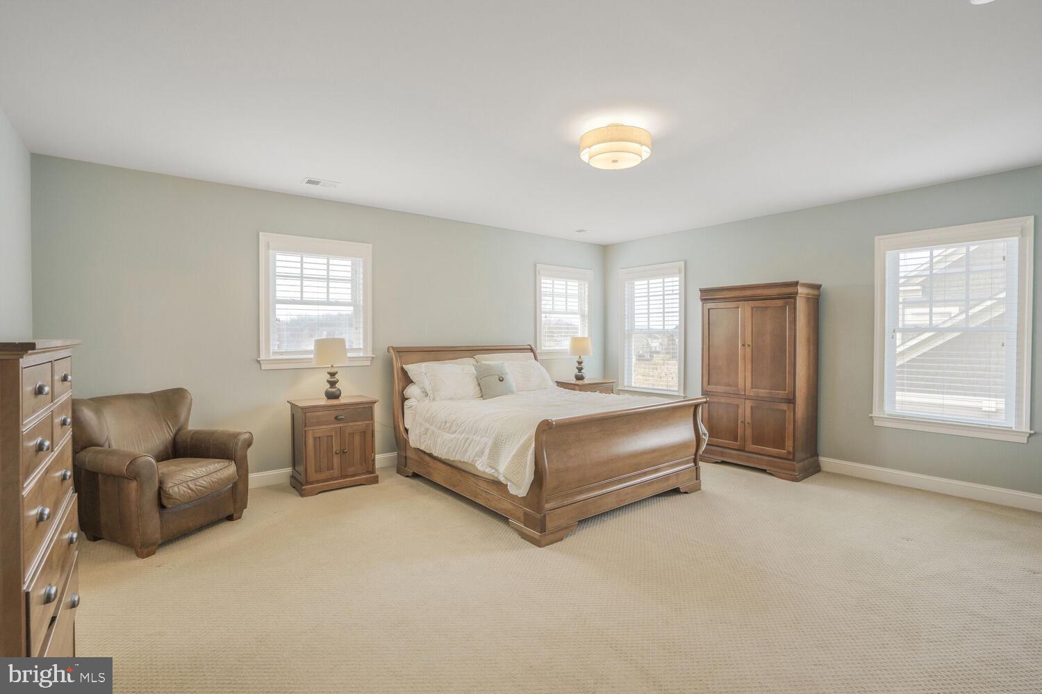 41729 Bloomfield Path Street Ashburn, VA 20148 - Photo 34 of 65 a bedroom with a bed couch and windows