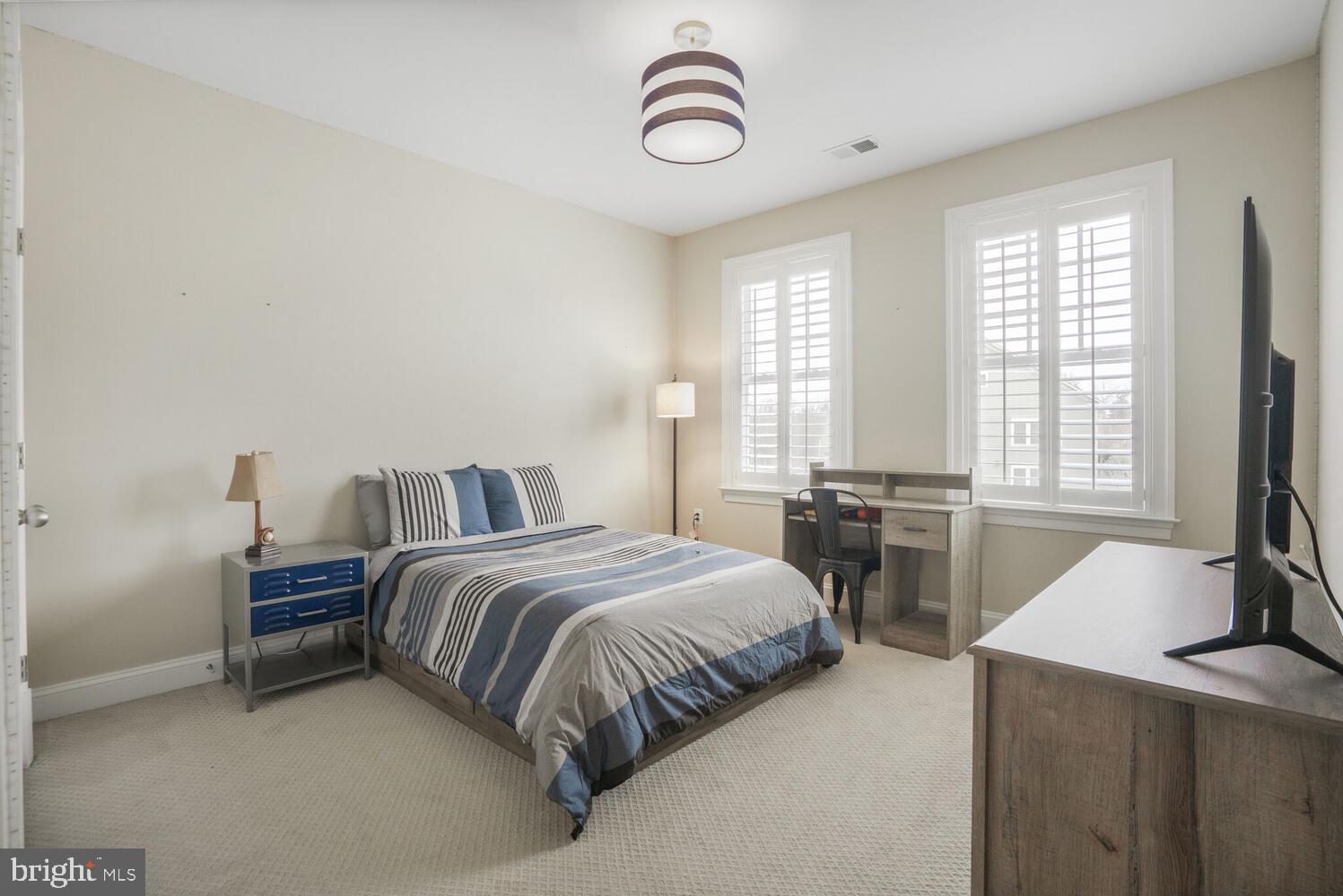 41729 Bloomfield Path Street Ashburn, VA 20148 - Photo 41 of 65 a bedroom with a bed and a flat tv screen on dresser