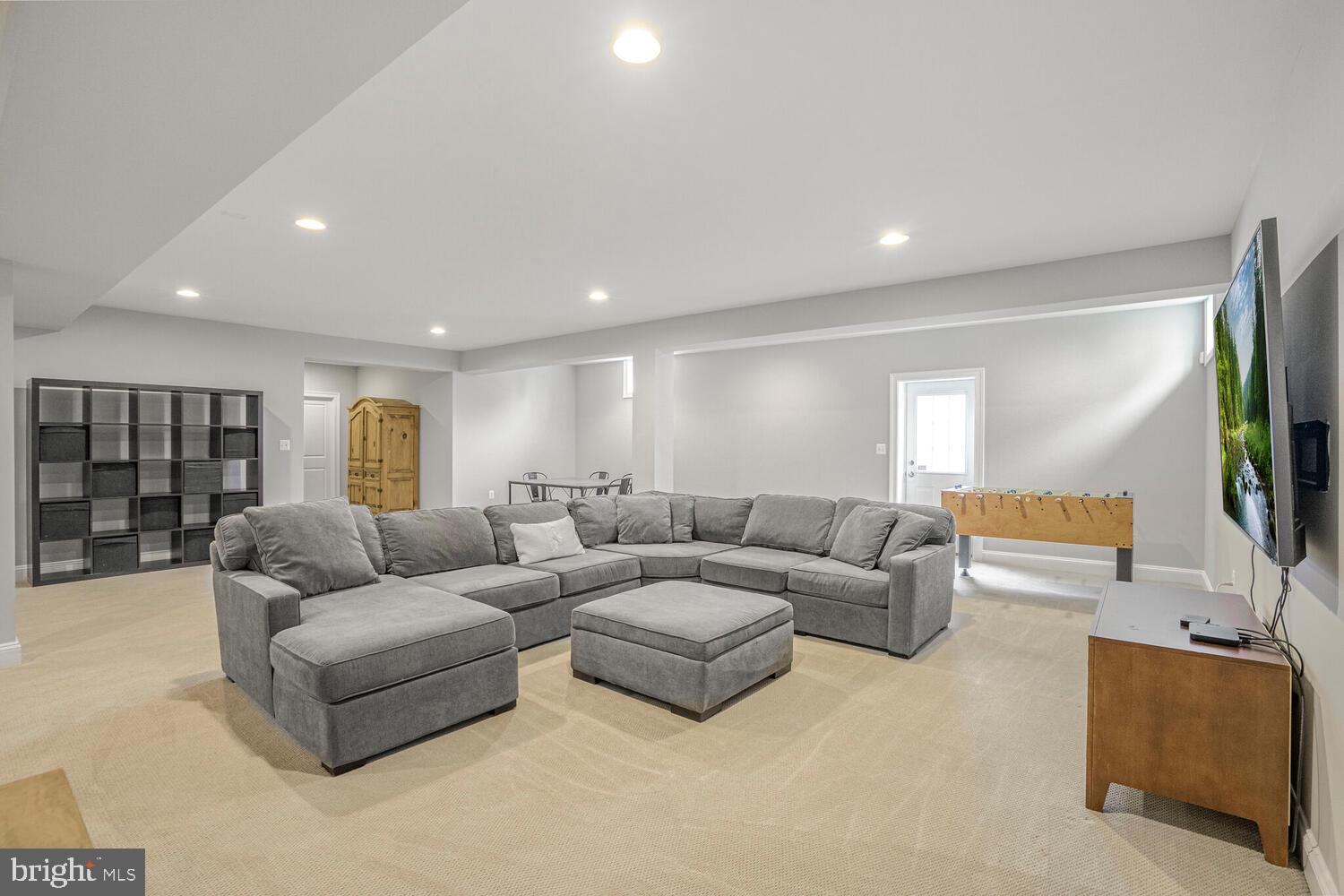 41729 Bloomfield Path Street Ashburn, VA 20148 - Photo 51 of 65 a living room with furniture and a flat screen tv