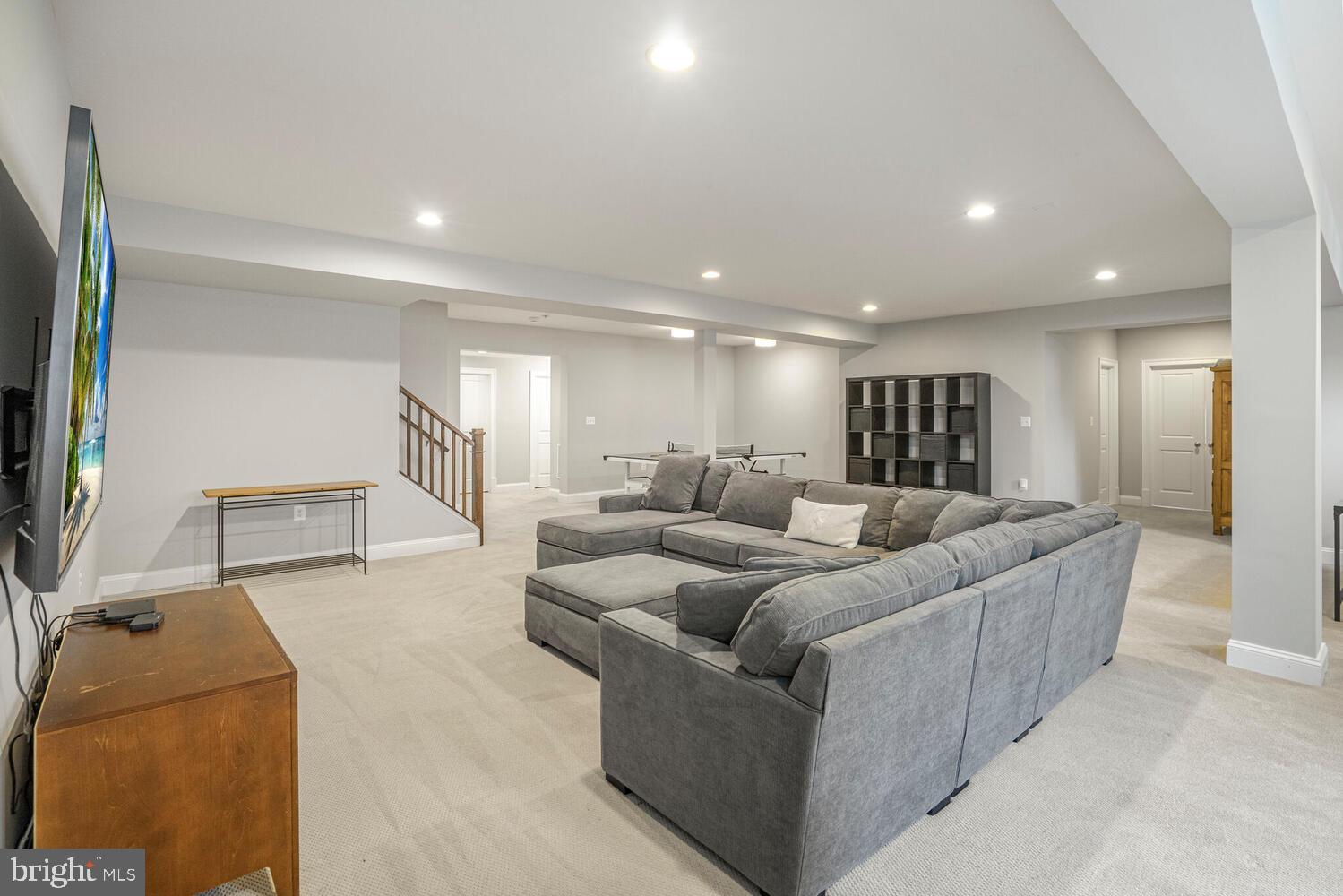 41729 Bloomfield Path Street Ashburn, VA 20148 - Photo 52 of 65 a living room with furniture and a flat screen tv