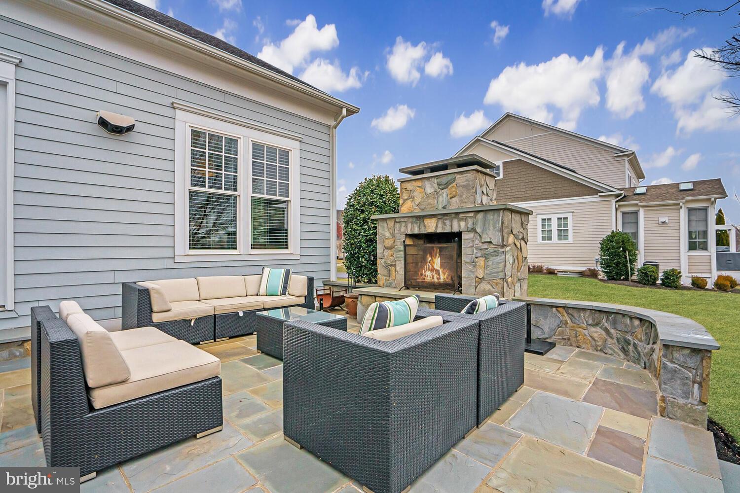 41729 Bloomfield Path Street Ashburn, VA 20148 - Photo 62 of 65 a view of a patio with couches chairs and a fire pit