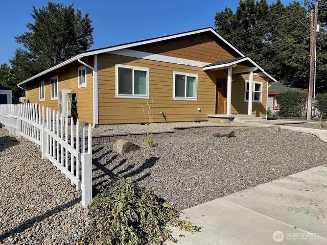 a front view of a house with wooden fence