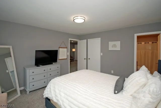 a bedroom with a bed and flat screen tv