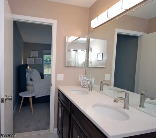a en suite bathroom with a sink and a mirror