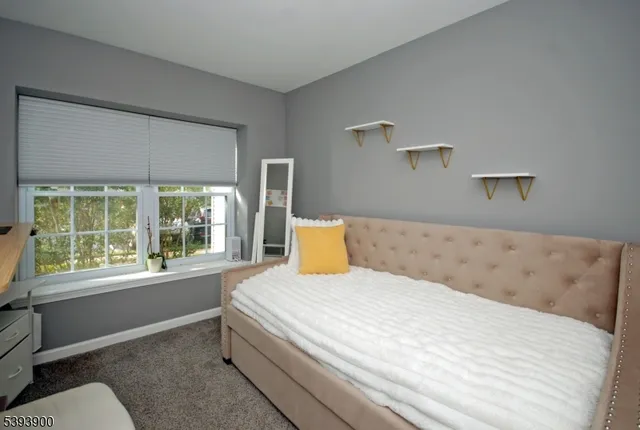 a bedroom with a large bed and a large window